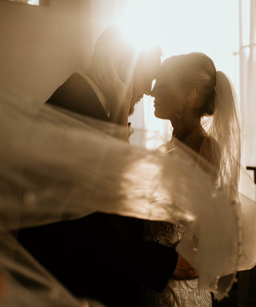 Warm Tone Indoor Wedding Romantic Long Veil Bride and Groom Portrait Photo