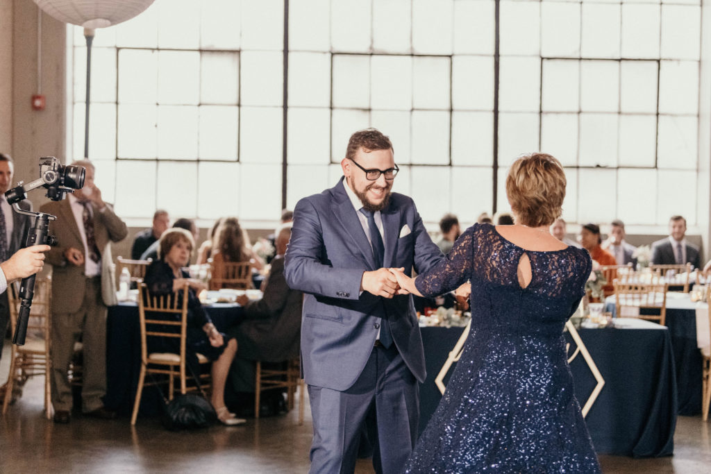 groom and mother dancing together at wedding reception at lake erie building
