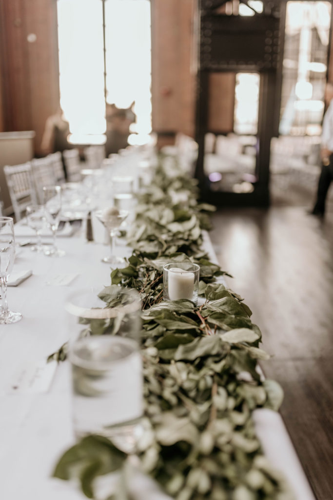 industrial wedding decor on table-candles and leaves