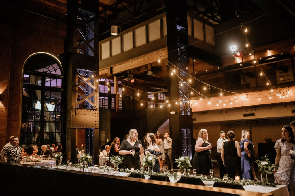 wedding reception at industrial wedding venue under hanging lights
