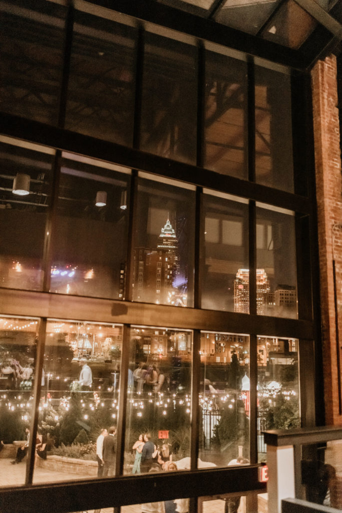 glass windows with cleveland skyline outside at industrial wedding venue
