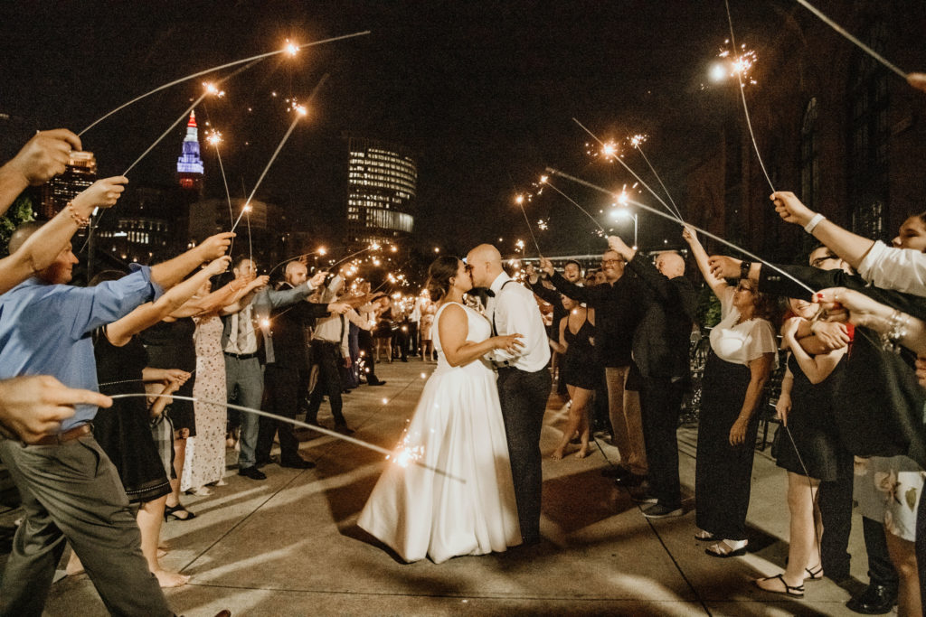 sparkler sendoff at wedding with bride and groom kissing in center