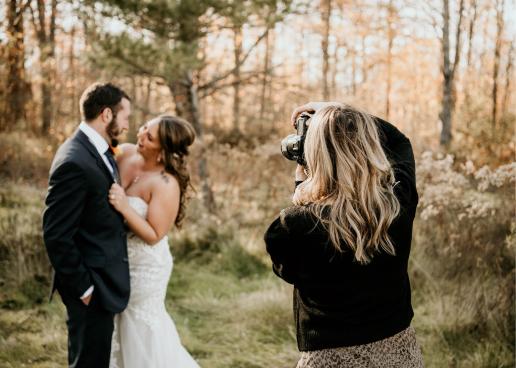 wedding photographer taking photo of bride and groom