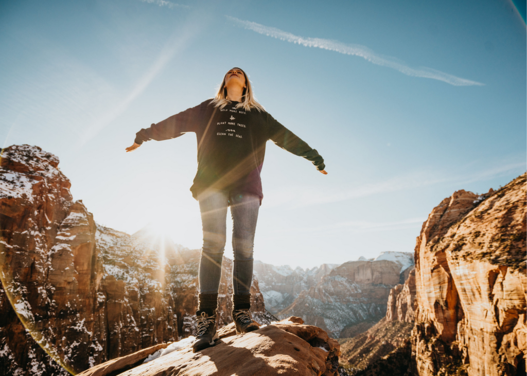 girl woman standing on mountain edge, utah national park