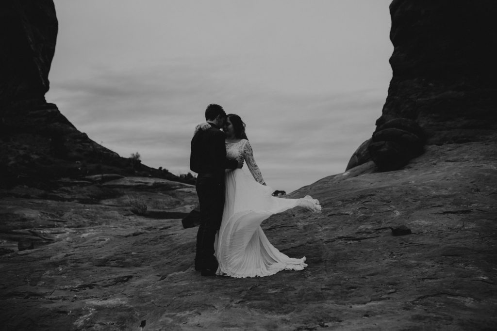 boho bride and groom dancing in arches national park